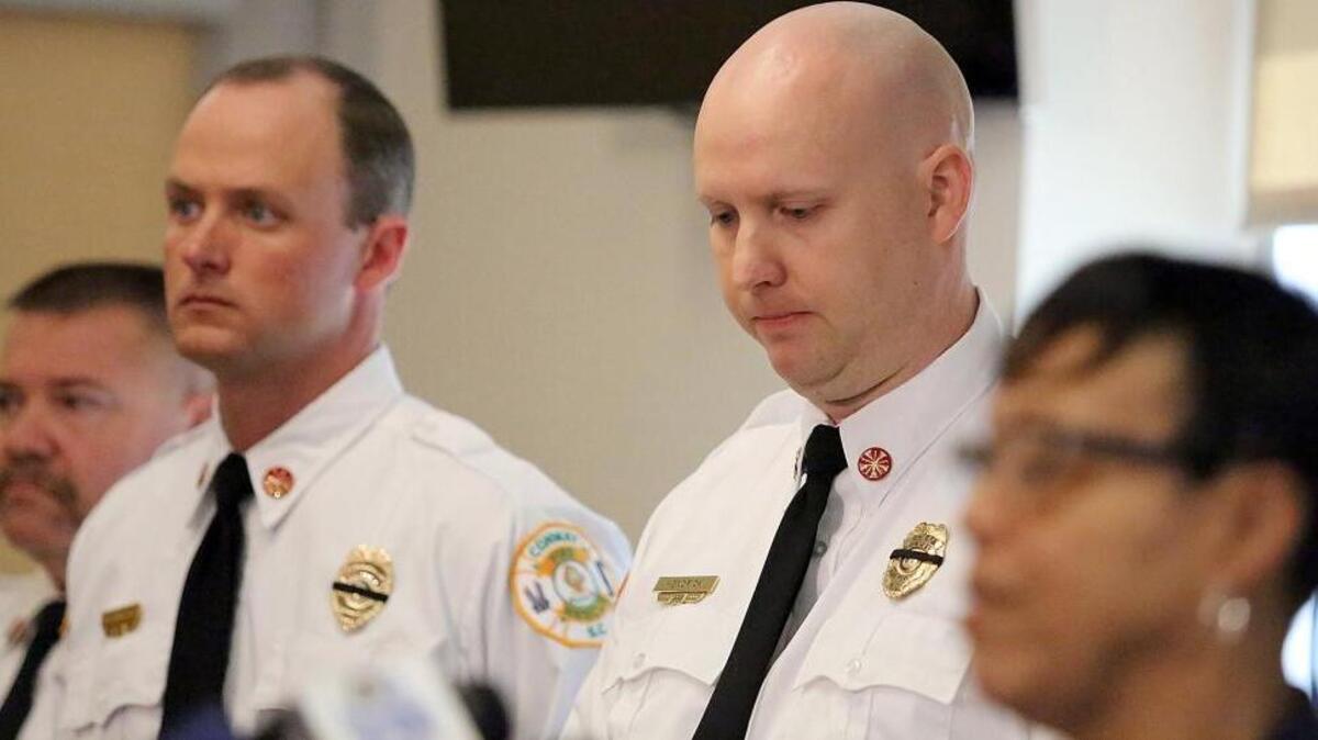 Conway Fire Chief Phillip L. Hendrick Jr. (second from right) listens as Conway Mayor Barbara Blain-Bellamy speaks about the city's loss of firefighter Chris Ray on March 21, 2016. Ray died on duty Sunday afternoon while responding to a fire within a half a mile from the fire house. He was struck and killed by a fire engine on Tinkertown Avenue, a street over from the burning home on Hickory Circle. The hydrant is on Tinkertown Avenue. Horry County coroner's office said preliminary autopsy results show multiple traumatic injuries. Ray had been a Conway firefighter since 2010. He leaves behind a wife and two daughters. Funeral arrangements had not been announced as of the afternoon of March 21.