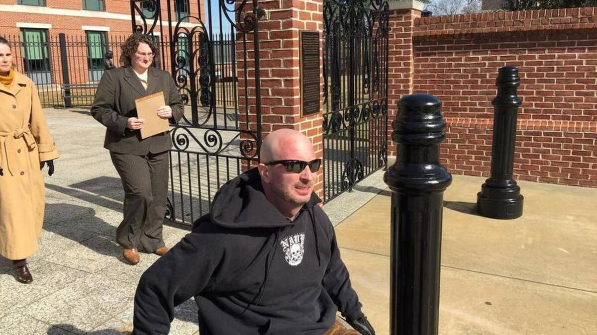 Dennis Paulsen leaves federal court in a wheelchair in January.