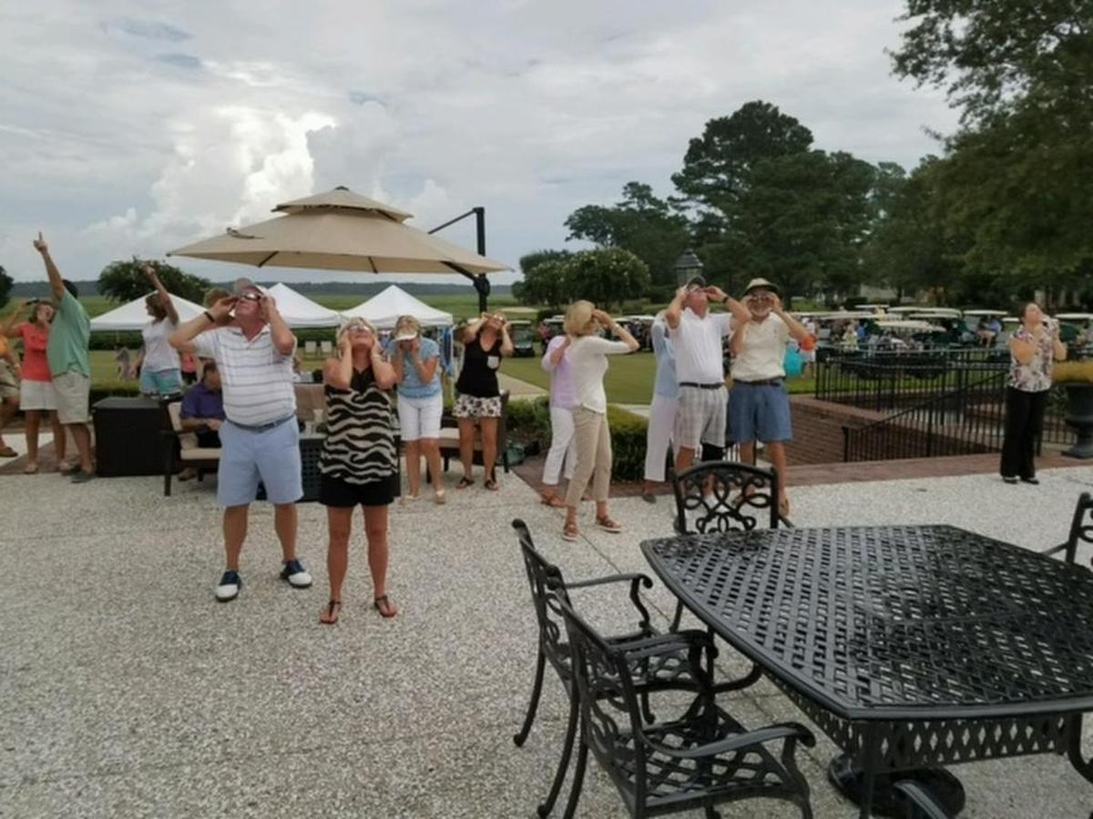 Baird Campbell took this photo of residents and guests getting a sneak peek of the eclipse at Bluffton's Belfair watch party.