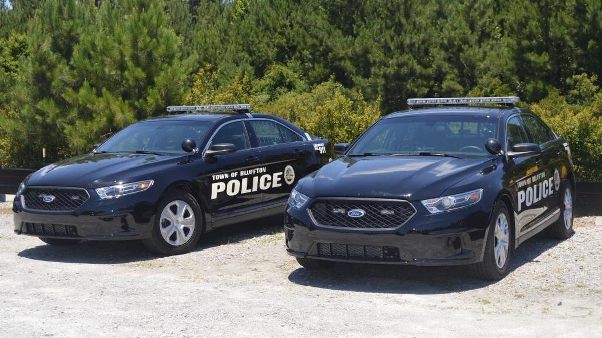 Vehicles from the Bluffton Police Department sit parked outside.