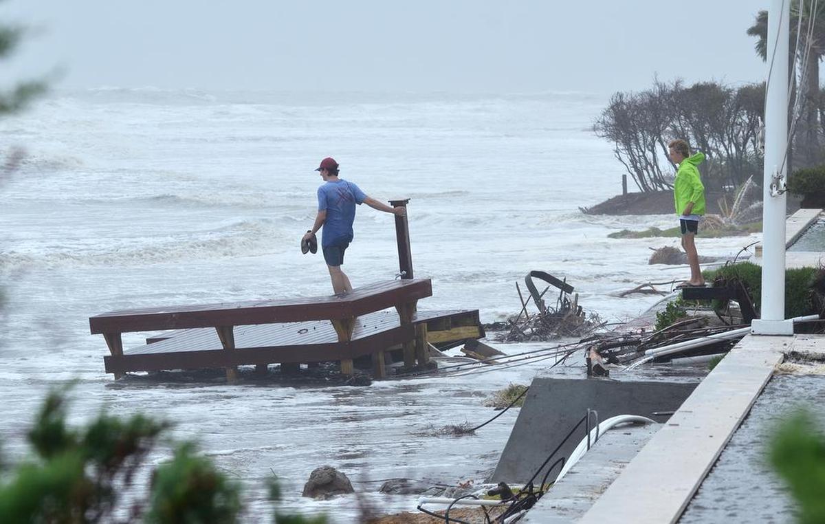 In this file photo, Austin Perry, 20, left, and Jimmy Thompson, 15, inspect the wreckage of a beachfront deck that was swept away by high surf from Hurricane Irma along South Beach in Sea Pines on Hilton Head Island on September 11, 2017.