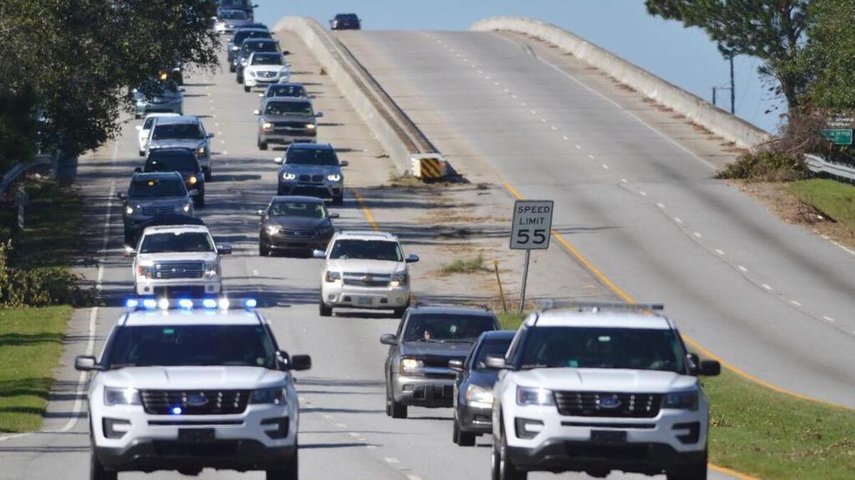 A pair of sheriff's office cruisers leads the parade of Hurricane Matthew evacuees back onto Hilton Head Island. The evacuation was rescinded and the public was allowed back on the island. The evacuation was lifted three days after the storm hit, at 3 p.m. on Oct. 11, 2016.