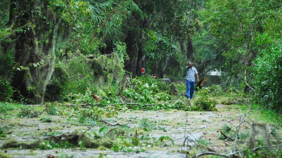 A man walks among the debris on a street in Bluffton after Hurricane Matthew hit.