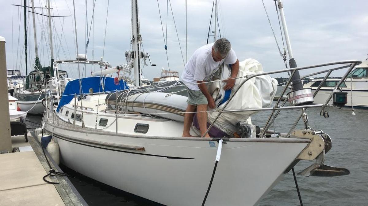 Boater Tom Hubbard, of Bluffton, packs away the jib sail of his 40-foot sailboat docked at Port Royal Landing Marina on Oct. 4, 2016, as he prepares the boat for Hurricane Matthew, which is expected to pass near Beaufort County this weekend.