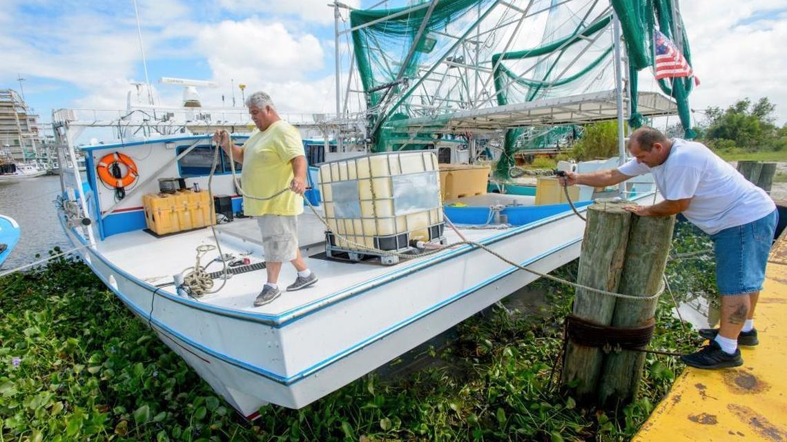 Scottie Lopez, left, and Glenn Greco, both from Delacroix Island, tie up their boats Friday in St. Bernard Parish, La., in anticipation of the arrival of Hurricane Nate.