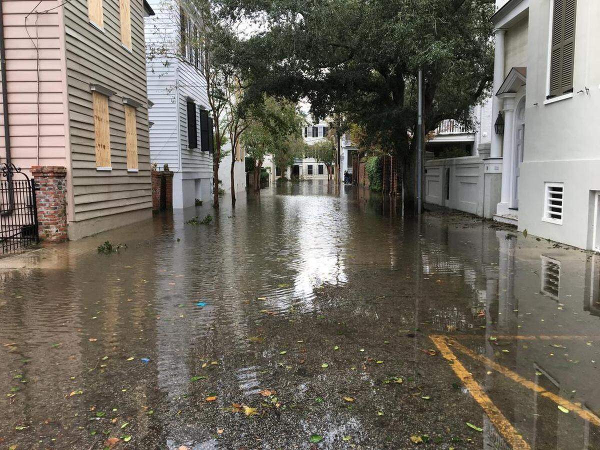 Lamboll Street, between King and Legare streets, remains flooded, as night approaches in Charleston on Saturday, Oct. 8, 2016.