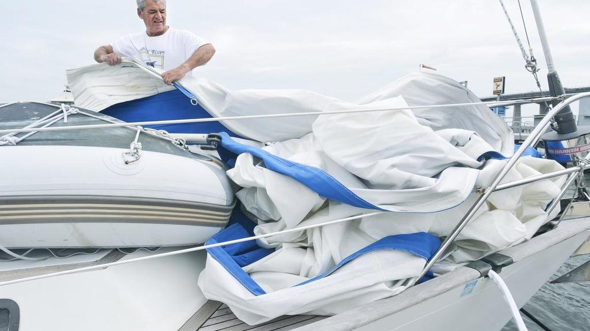 Boater Tom Hubbard, of Bluffton, packs up the jib sail as he secures his 40-foot sailboat docked at Port Royal Landing Marina in preparation for Hurricane Matthew.