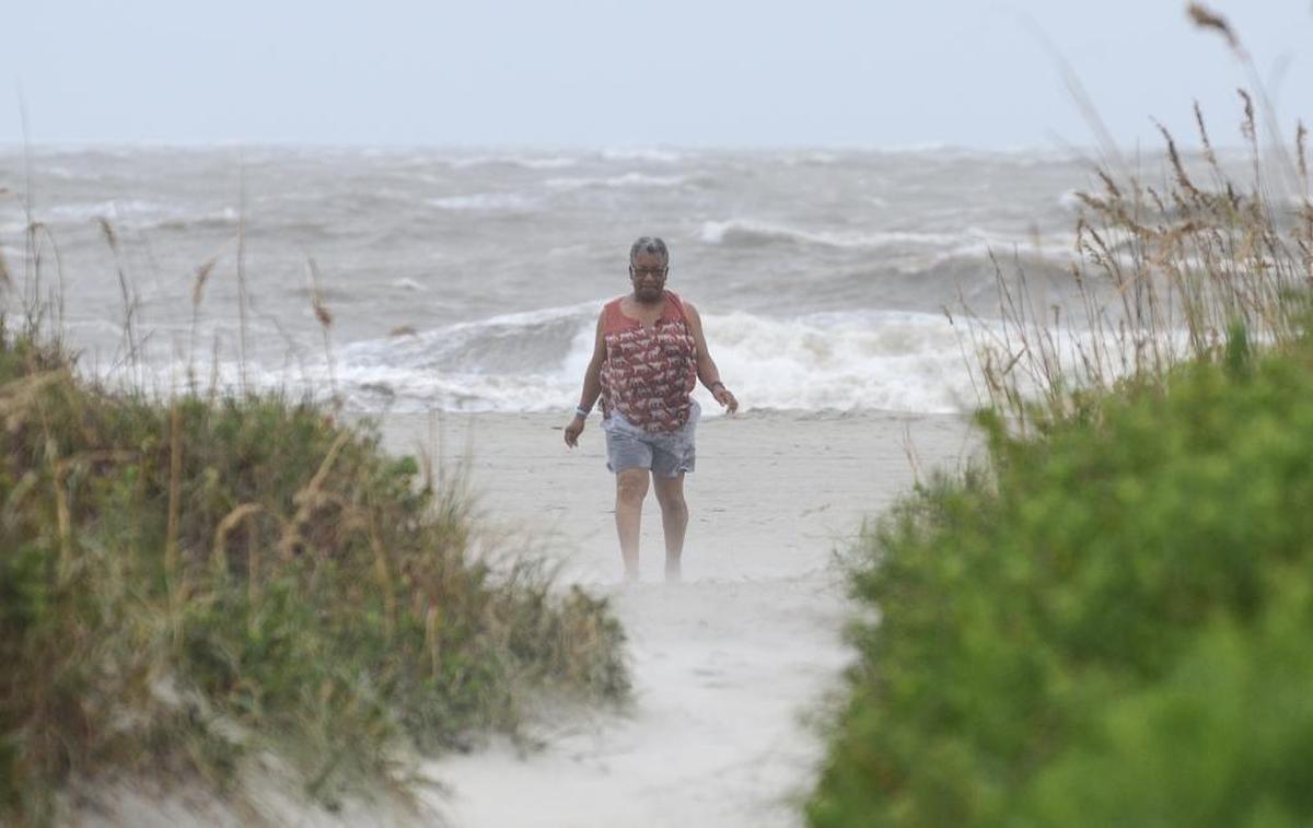 Bonita Peele, of Concord, N.C., walks through wind and blowing sand from Tropical Storm Hermine on Hilton Head Island's South Forest Beach the morning of Sept. 2, 2016. Having watched coverage of tropical systems over the years, Peele decided to come out and see a storm for herself. "I think it's wonderful to experience it," she said. "It's God in action."