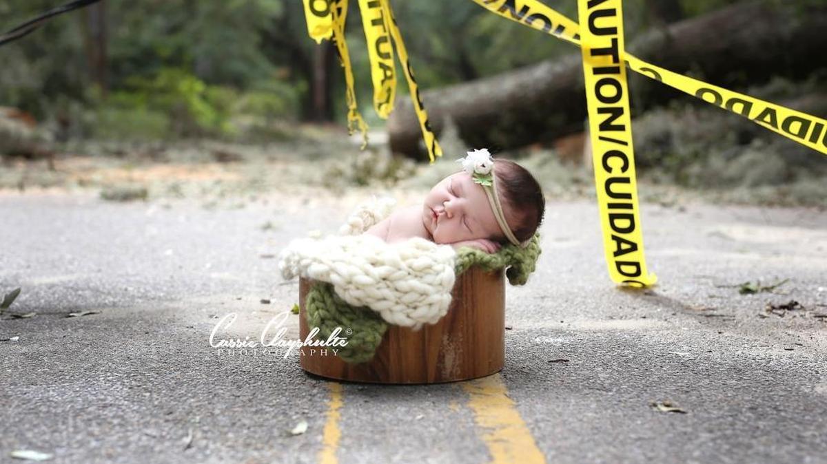 Charlotte Young is one of the hurricane babies Cassie Clayshulte posed near downed trees and other storm debris to commemorate the time they were born.