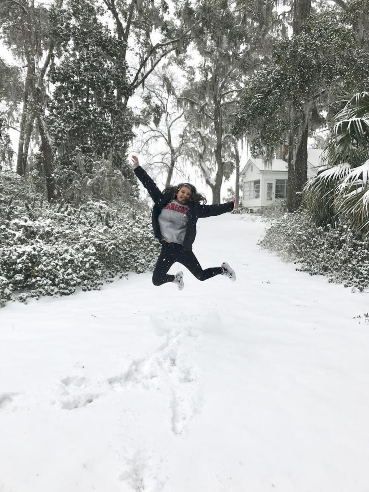 Lucy Bruns took this photo of Heily Hernandez jumping in delight after the snowfall at a home in Pigeon point in Beaufort on Wednesday.