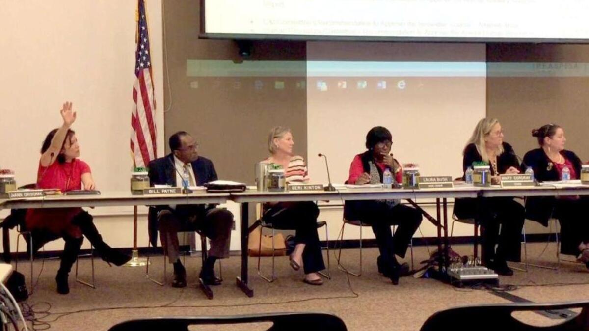 Beaufort County Board of Education member JoAnn Orischak raises her hand during school board meeting.