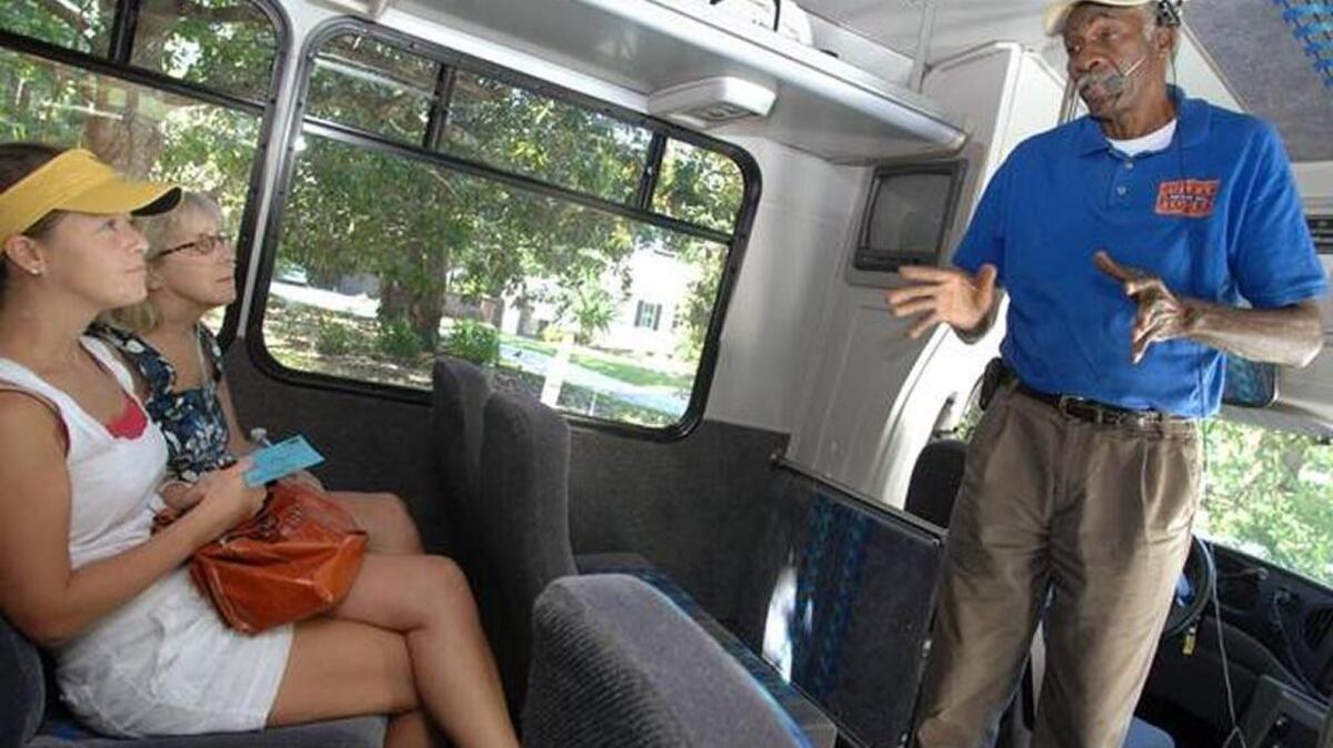 Visitors from Atlanta listen as Gullah Heritage Trail Tour driver and narrator Emory Campbell gives a quick overview of Hilton Head Island history at the start of a bus tour of the island in 2010.