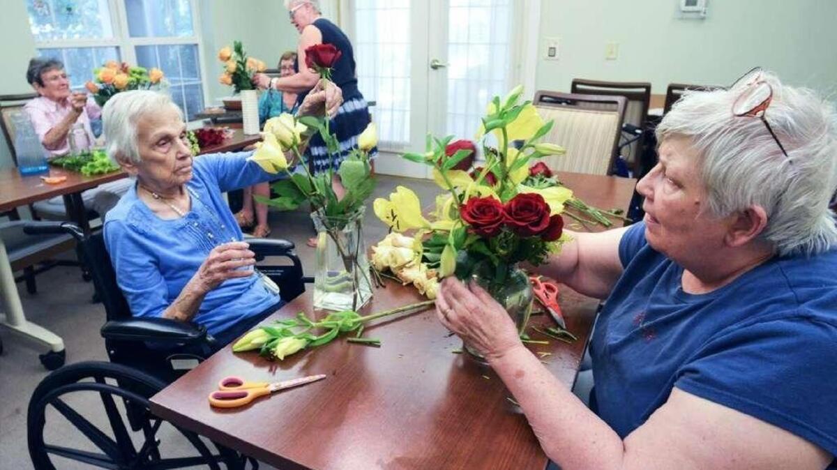 Rita Wegmann, left, and Diana Brown, residents at Bloom at Bluffton retirement home, participate in a flower arranging class. In the next two years, Beaufort County can expect a 33 percent increase in its capacity for senior housing.