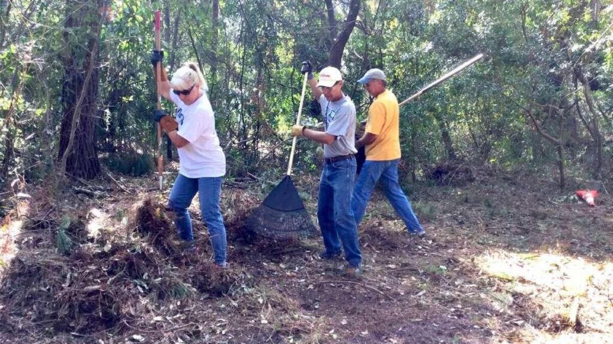 From left, Barbara Wiebe, Bill Wiebe and Rick Van Puffelen of Hilton Head Presbyterian Church clean up from Hurricane Matthew at a home off Marshland Road.