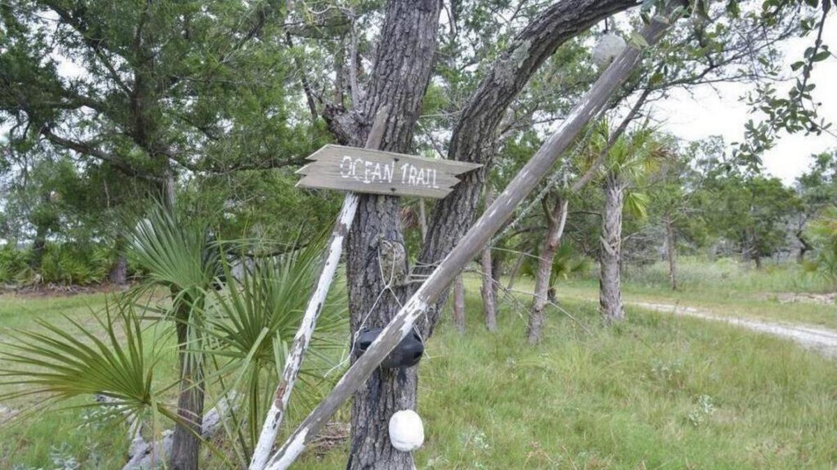 A rustic sign marks one of the trails on Bay Point Island on Sept. 22, 2016.