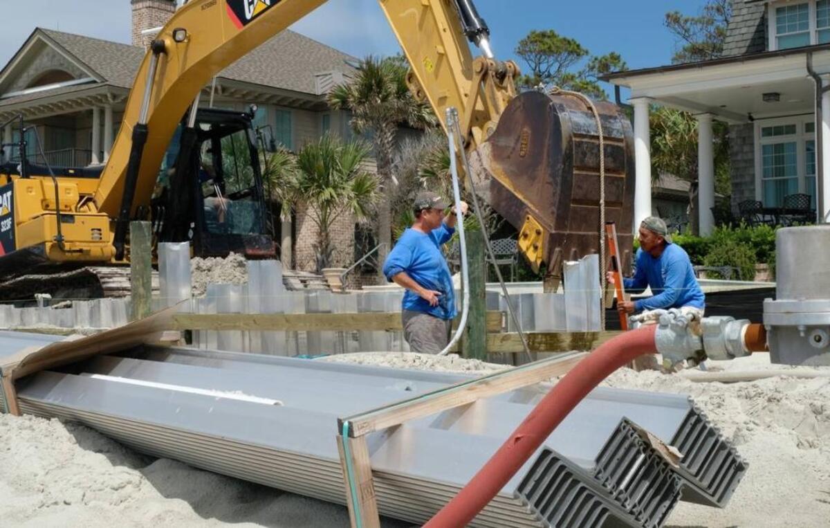 Workers installing a seawall in front of several properties along Piping Plover Road on Hilton Head Island in 2018.