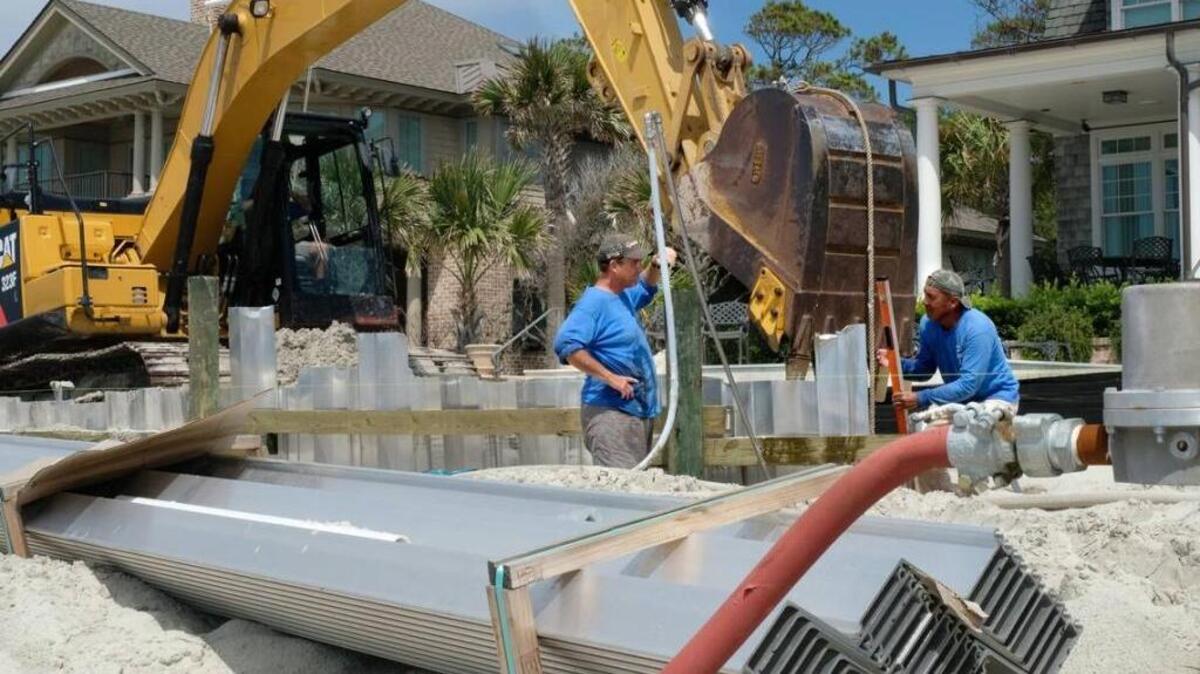 Workers installing a seawall in front of several properties along Piping Plover Road on Hilton Head Island.