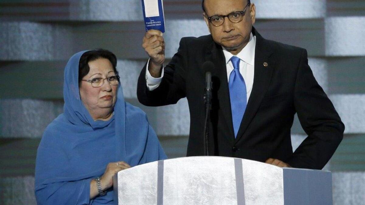 Khizr Khan holds a copy of Constitution of the United States, that he offered to lend to Donald Trump, with his wife Ghazala Khan, during the last day of the Democratic National Convention at the Wells Fargo Center in Philadelphia on Thursday, July 28, 2016.