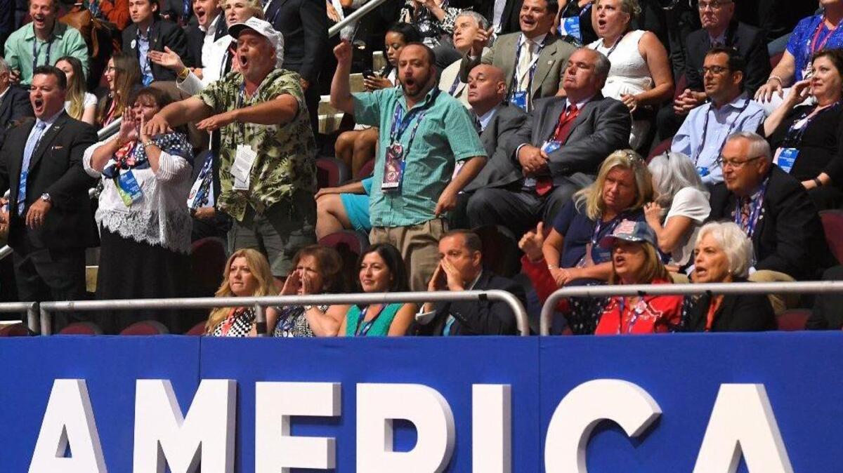 Attendees shout as Sen. Ted Cruz, R-Tex., delivers his speech during the third day of the Republican National Convention in Cleveland, Wednesday, July 20, 2016.