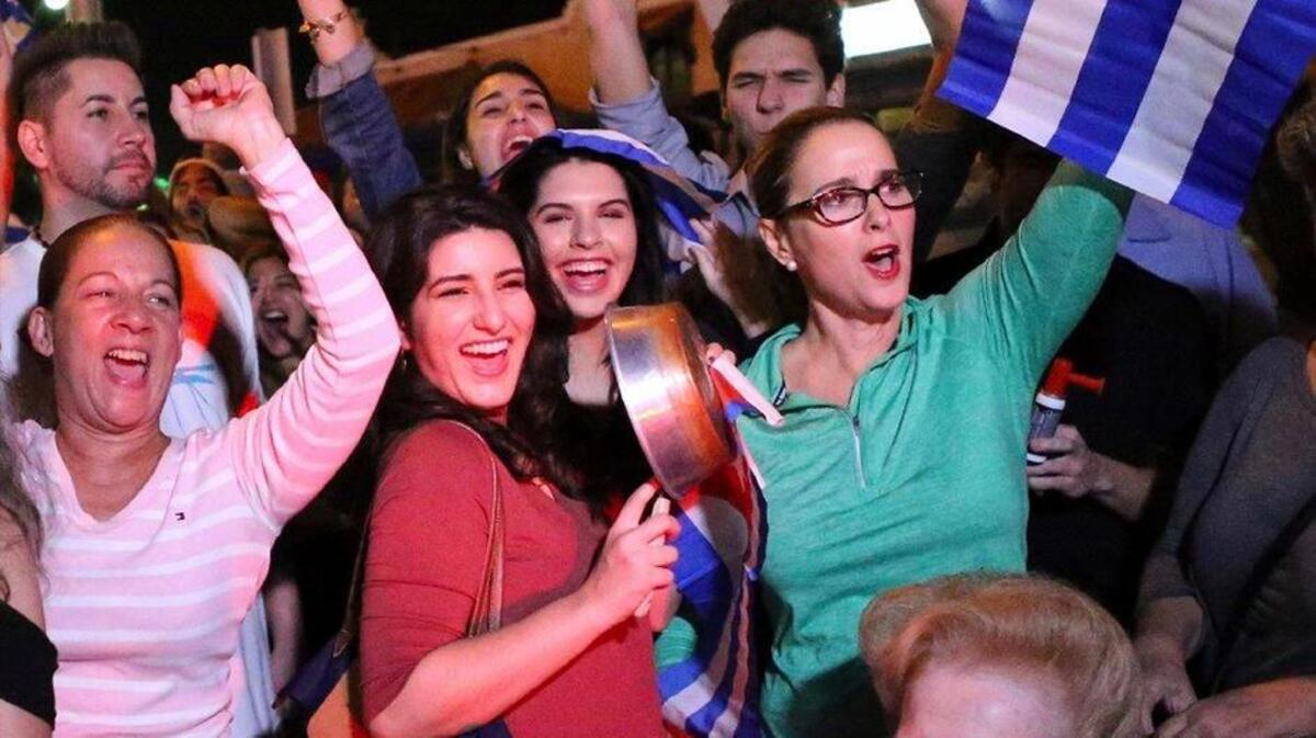 The Cuban community in Miami celebrates the announcement that Fidel Castro died in front La Carreta Restaurant early Saturday, Nov. 26, 2016, in Miami. Within half an hour of the Cuban government’s official announcement that former President Fidel Castro had died, Friday, Nov. 25, 2016, at age 90, Miami’s Little Havana teemed with life — and cheers.