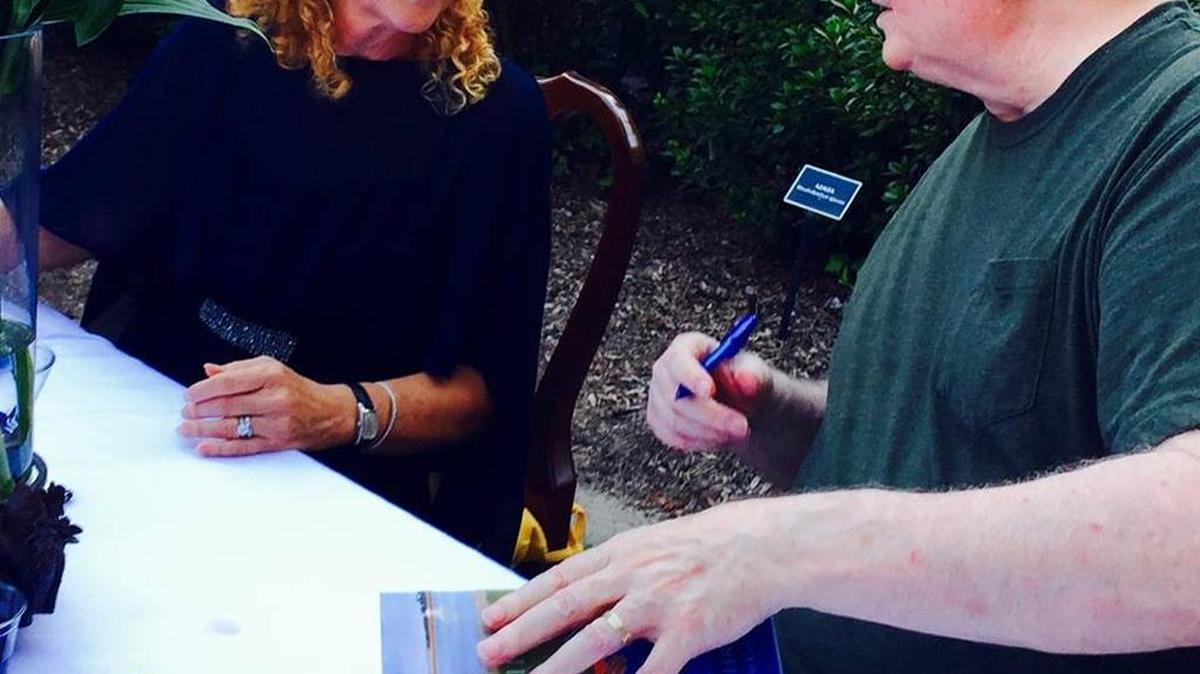Pat Conroy signs his foreword in “Untying the Moon” alongside debut novelist Ellen Malphrus at the book launch on Oct. 16, 2015 in Bluffton. Her novel is published by Story River Books.