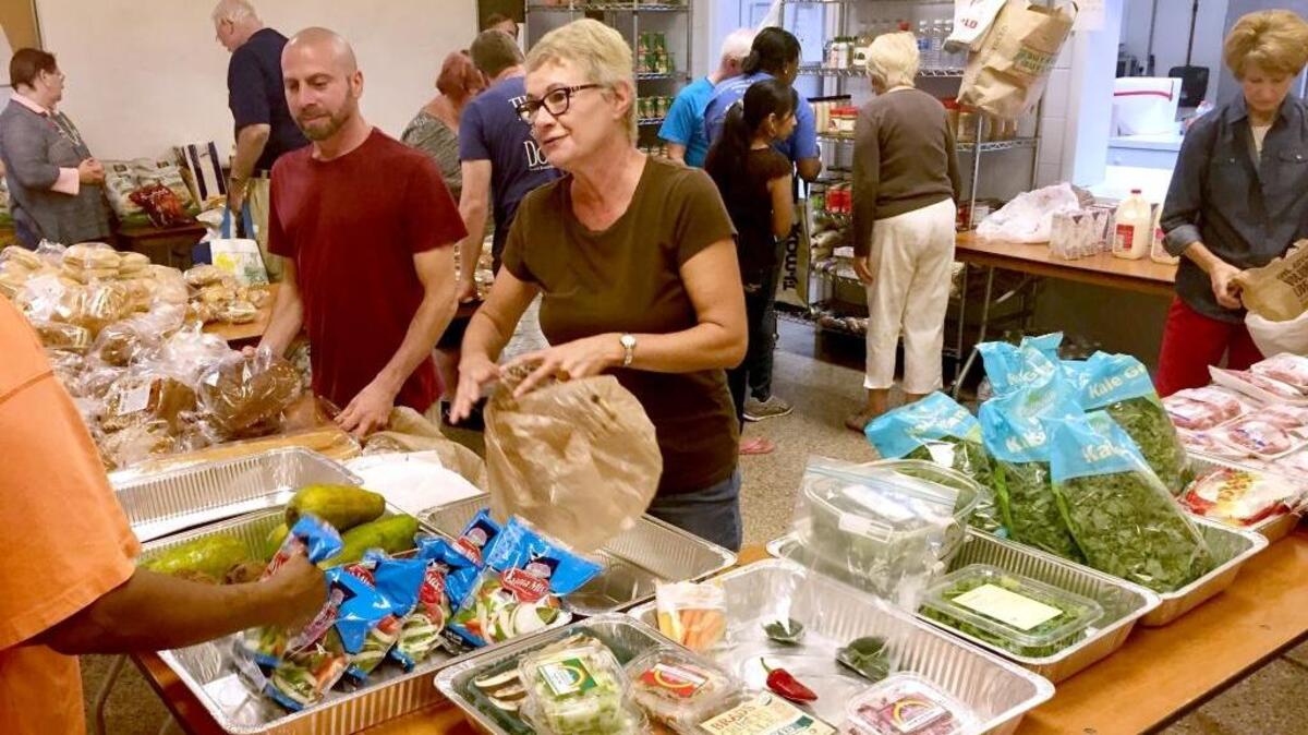 Society of St. Vincent de Paul volunteers John Musiello Jr. and Cathy Thomas of Hilton Head Island work in the food pantry at Holy Family Catholic Church Thursday, Oct. 20, 2016.