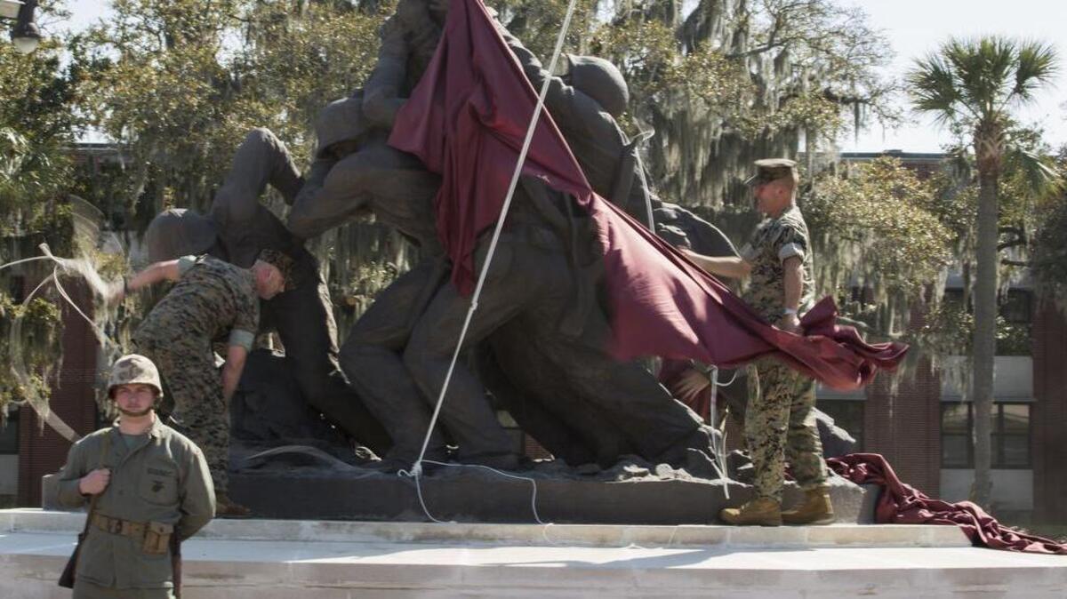 Marines of Headquarters and Service Battalion unveil the Iwo Jima statue onMarch 14, 2016, on Marine Corps Recruit Depot Parris Island after restorations were recently completed. The work addressed issues on both the interior and exterior, and will extend the life of the statute by an estimated 20 years or more.