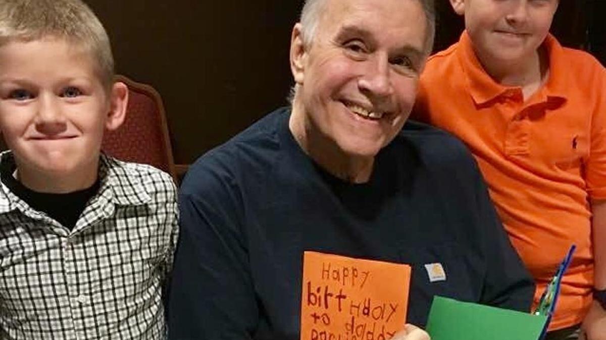Charlie Golson holds handmade birthday cards with grandsons, Henry, left, and William Golson during a party on his 69th birthday Oct. 10 at NHC HealthCare in Bluffton.