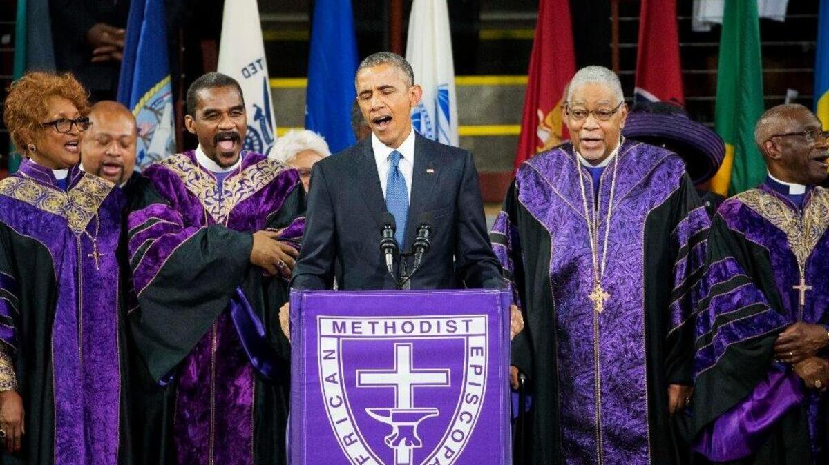 President Barack Obama sings “Amazing Grace” during services honoring the life of the Rev. Clementa Pinckney, June 26, 2015, at the College of Charleston TD Arena in Charleston, S.C. Pinckney was one of the nine people killed in the shooting at Emanuel AME Church last week in Charleston. A year later, there were few signs of grace at a nearby court hearing in the case of another violent death.