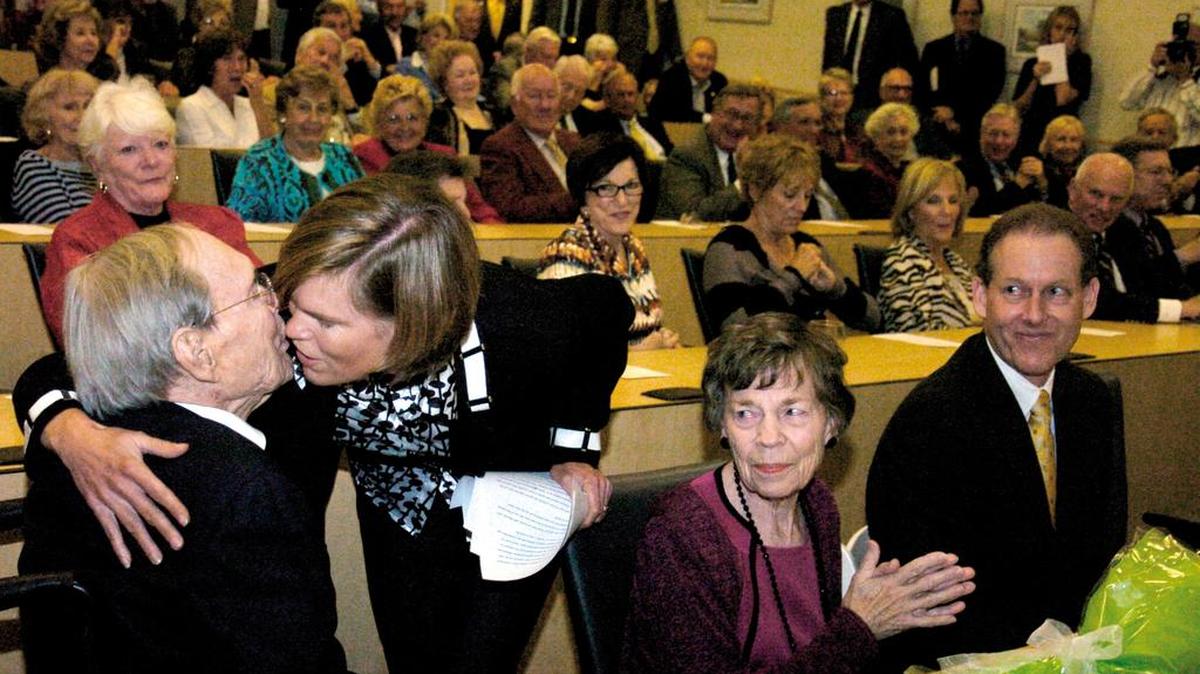 In this photo taken on Nov. 4, 2011, Angus Cotton gets a kiss from daughter Caneel after she spoke on behalf of the Cotton family during the dedication of the Angus Cotton Academic Center at the Technical College of the Lowcountry in Bluffton. At center is his wife, Beverly Cotton.