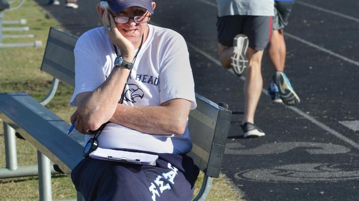 Hilton Head Island High School cross country coach Bill Wrightson watches on Wednesday as his squad practices for Saturday’s state cross country meet. The boys team won the state championship for the fifth year in a row, and the girls finished second.