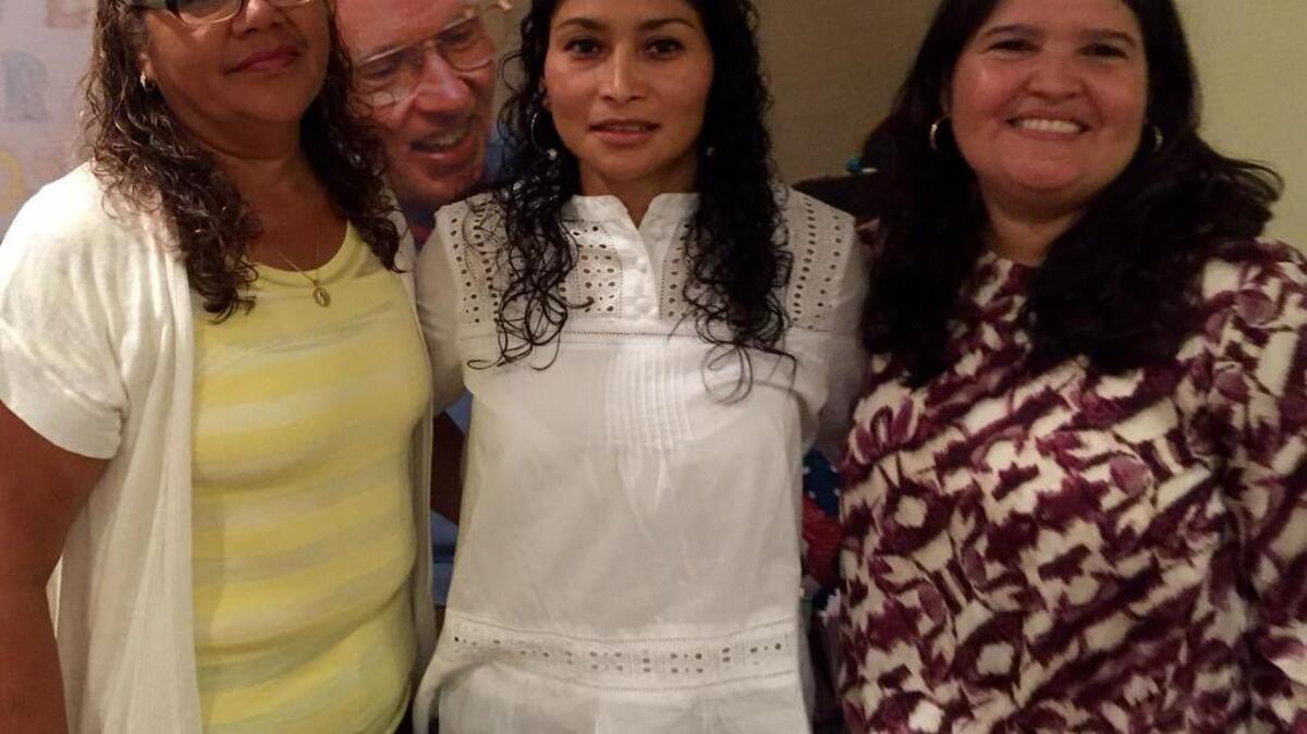 Latinos Unidos Food Festival organizers, from left, Lola Arevalo, Miriam Hernandez and Nena Balzola at the Volunteers in Medicine Clinic on Hilton Head Island with a picture of founder Dr. Jack McConnell on the wall behind them.