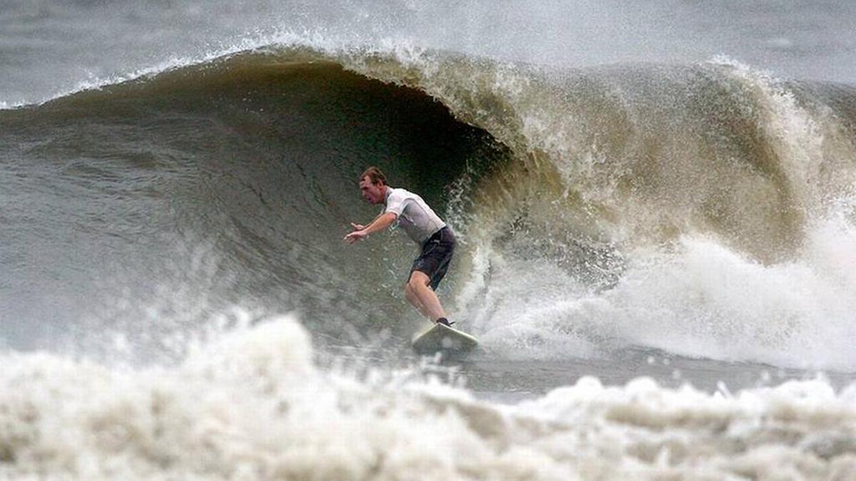 Timmy Rentz of Beaufort rides down the face of a large wave at Hunting Island as Hurricane Irene travels up the east coast, Friday, Aug. 26, 2011.