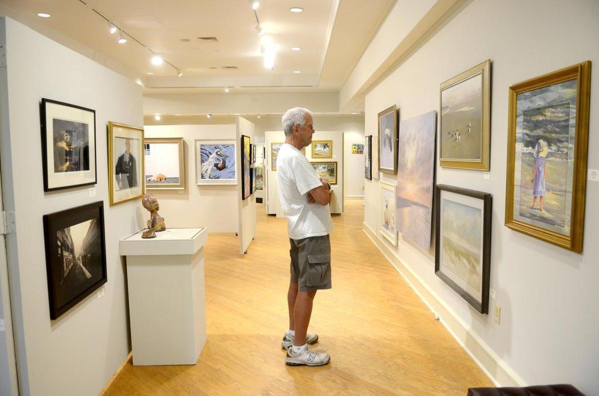Arnold Frederick, of Richmond, Va., looks at paintings by Jim and Addison Palmer May 3, 2016 in the Art League of Hilton Head Gallery at the Arts Center of Coastal Carolina on Hilton Head Island.