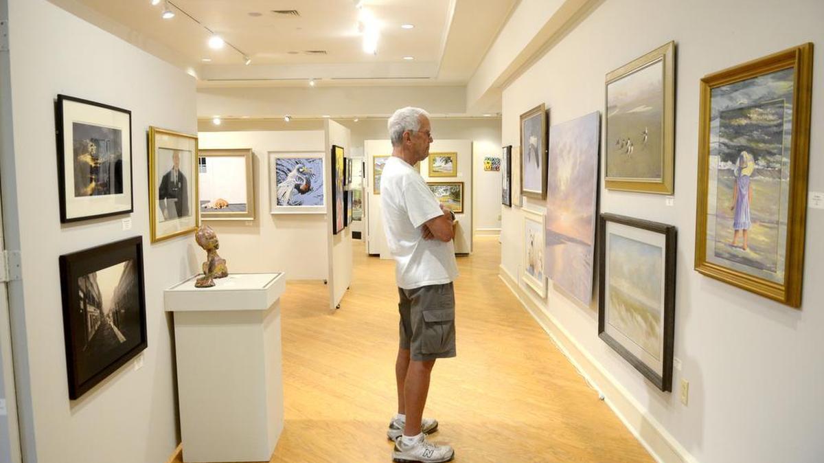 Arnold Frederick, of Richmond, Va., looks at paintings by Jim and Addison Palmer May 3, 2016 in the Art League of Hilton Head Gallery at the Arts Center of Coastal Carolina on Hilton Head Island. The exhibit runs through May 28 from 10 a.m. to 4 p.m. and the reception for the exhibit will be held on May 5, 2016 from 5-7 p.m.