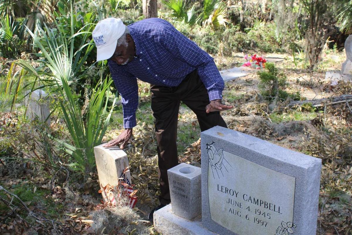 Hilton Head Island Gullah leader Emory Campbell surveys the tombstones of his grandparents, Rosa and Perry Williams, at the Spanish Wells Cemetery where many trees were uprooted by Hurricane Matthew in October 2016.