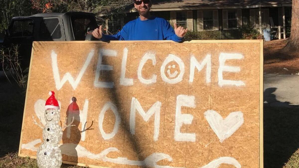 Dante Liska poses with the “Welcome Home” sign that greeted motorists returning to Hilton Head Island after the evacuation for Hurricane Matthew in October.