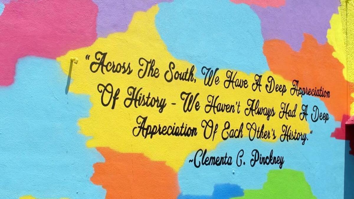 A quote from the Rev. Clementa Pinckney, one of the victims of the June 2015 shootings at Emanuel AME Church in Charleston, S.C., is seen on a mural unveiled on a building in Charleston a few blocks from the church on Friday, May 13, 2016. The mural was created by noted artist Tripp Derrick Barnes to honor the nine shooting victims as the first anniversary of the slayings approaches.