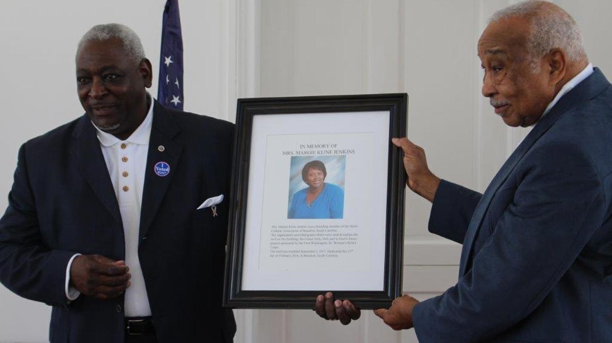 The Rev. Sam Spain, left, and Port Royal Mayor Sam Murray with photograph of Margie Kline Jenkins Feb. 27 at the Grand Army of the Republic Hall in Beaufort.