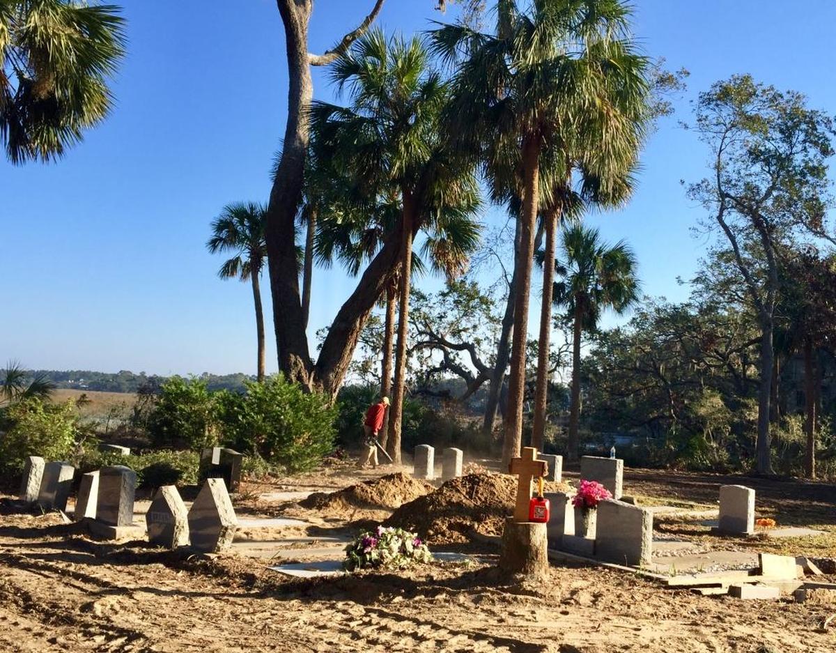 A volunteer puts finishing touches on the restored Talbird Cemetery on the morning of the Rev. Ben Williams’ burial on Nov. 19, 2016.