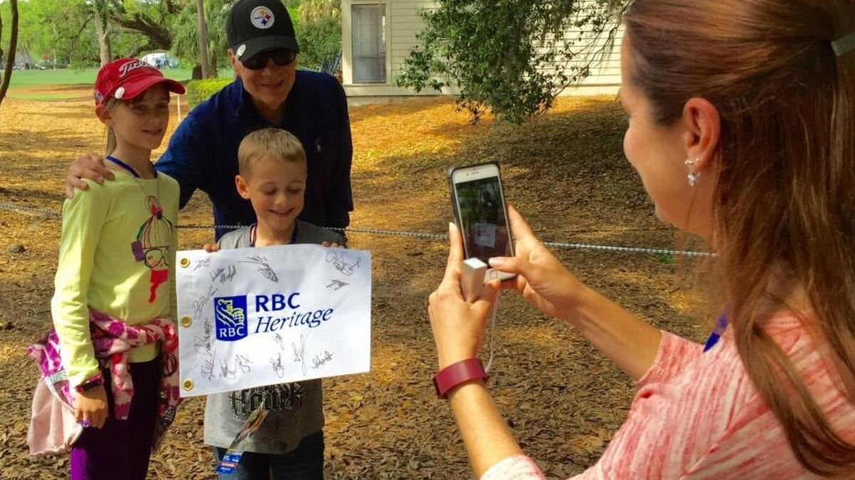 Pittsburgh Steelers president and co-owner Art Rooney II poses for fans between holes in the RBC Heritage Presented by Boeing pro-am Wednesday, April 13, 2016. Jaime Marcotte of Bluffton snaps the picture with her children, Reese and Jordan.
