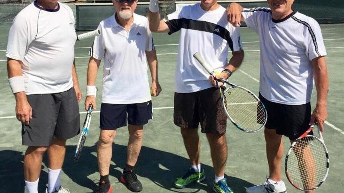 Robb Warren of Moss Creek holds a sheepshead fish that fell from the sky during the 31st Anniversary BillyBOB Century Cup Doubles Tournament at South Beach Racquet Club. From left are Bob Brockman, Joe Keenan, Warren and Don Benjamin.