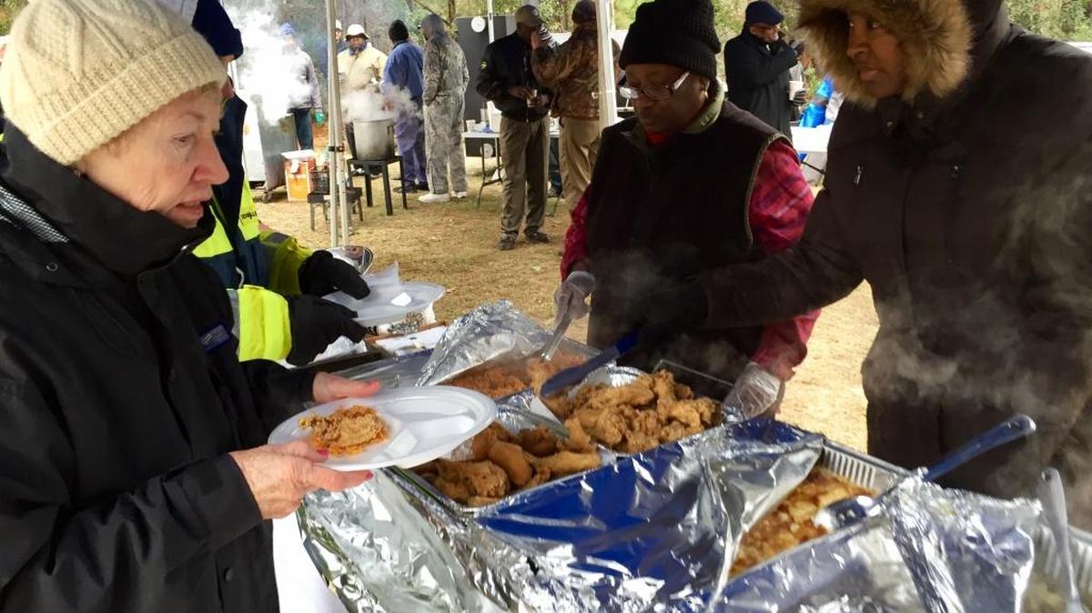 Suzie Allen goes through the serving line at the cookout held Saturday, Jan. 7, 2016 at Jarvis Creek Park on Hilton Head Island to thank volunteers and donors who helped restore the Gullah Talbird Cemtery after Hurricane Matthew. Annie Mae Miller Grant, center, helped organize the event.