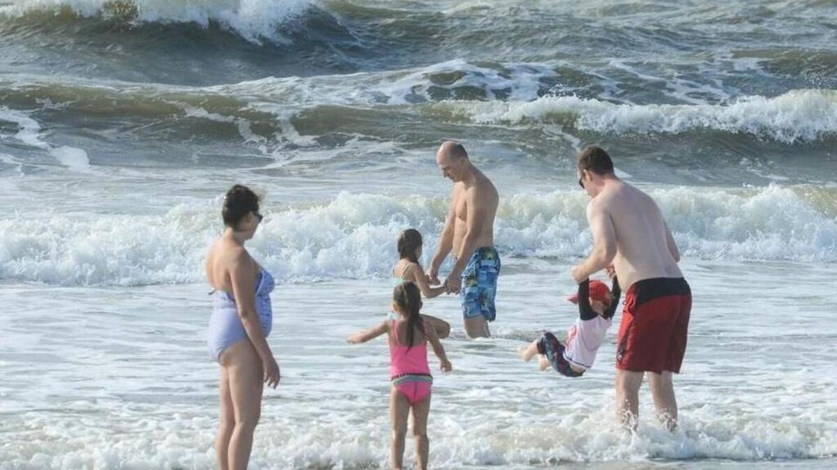 In this file photo, beach goers enjoy the surf on Hilton Head Island.