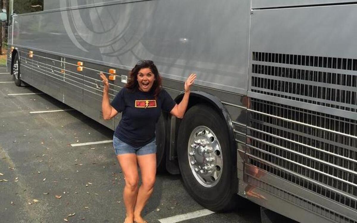 Kati Schroeder poses in front of one of Pearl Jam’s tour buses Wednesday afternoon in Port Royal Plantation.