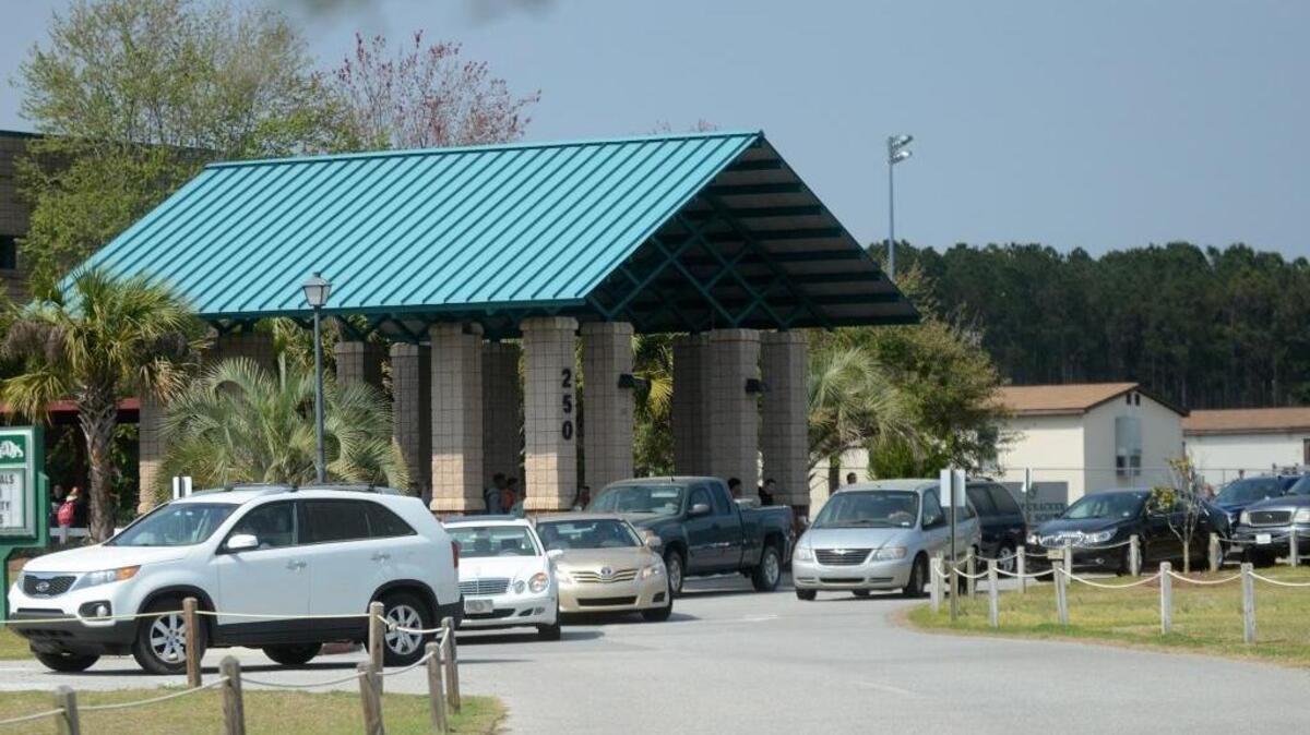 Parents wait in line to pick up their children at H.E. McCracken Middle School in Bluffton last March.