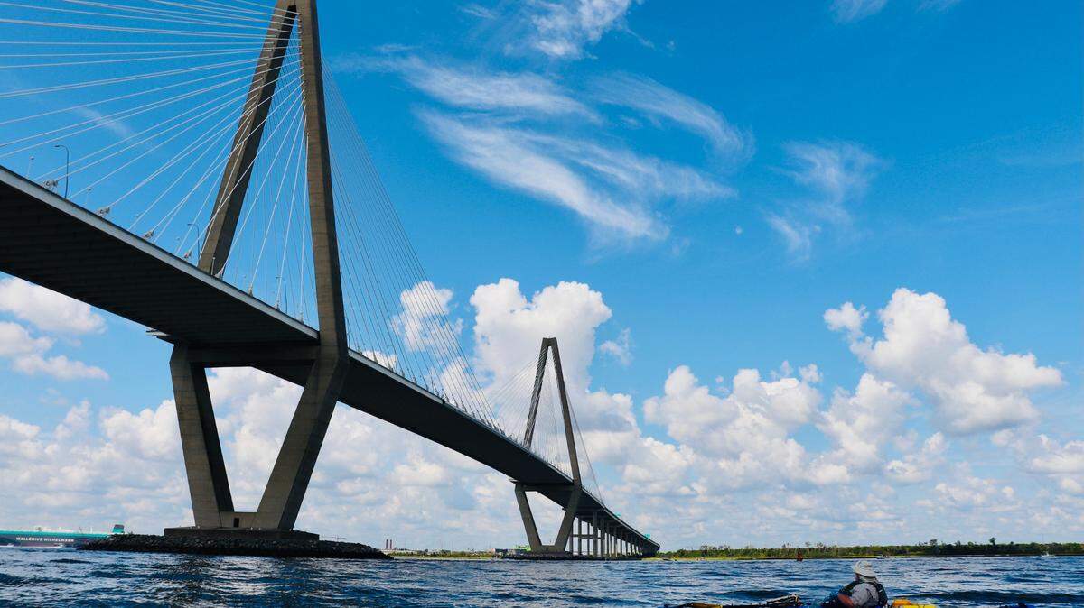 Kayaker Tom Taylor of Greenville paddles beneath the towering Arthur Ravenel Bridge in Charleston Harbor. With good planning and a sense of adventure, you can enjoy the history and beauty of the city of Charleston by water.