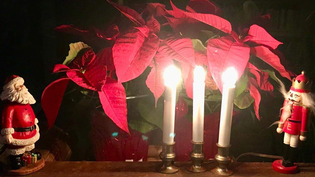 Three little candle lamps in the window somehow carry the light of the world.