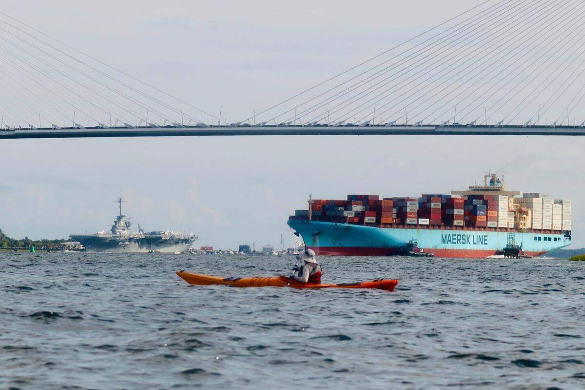 Playing in traffic: Kayaker Steve Houghtaling of Savannah contemplates an approaching container ship as he makes his way across Charleston Harbor near the Charleston Coal Tipple ruins. Charleston is one of the busiest seaports on the east coast, and boating in the harbor can be a challenge for the unwary, as well as an exciting adventure for those seeking to enjoy the history and beauty of the Lowcountry.