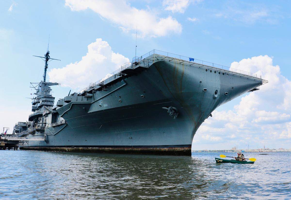 The Fighting Lady: The USS Yorktown (CV-10) is a WWII-era U.S. Navy aircraft carrier and the pride and joy of the Patriot’s Point Naval & Maritime Museum in Charleston Harbor. Thousands of visitors flock to this historic site every year to see and experience history. Here, kayaker Bob Tucker of Bluffton is dwarfed by the huge ship as he paddles past while exploring Charleston Harbor on his way to visit the ruins of the Charleston Coal Tipple.